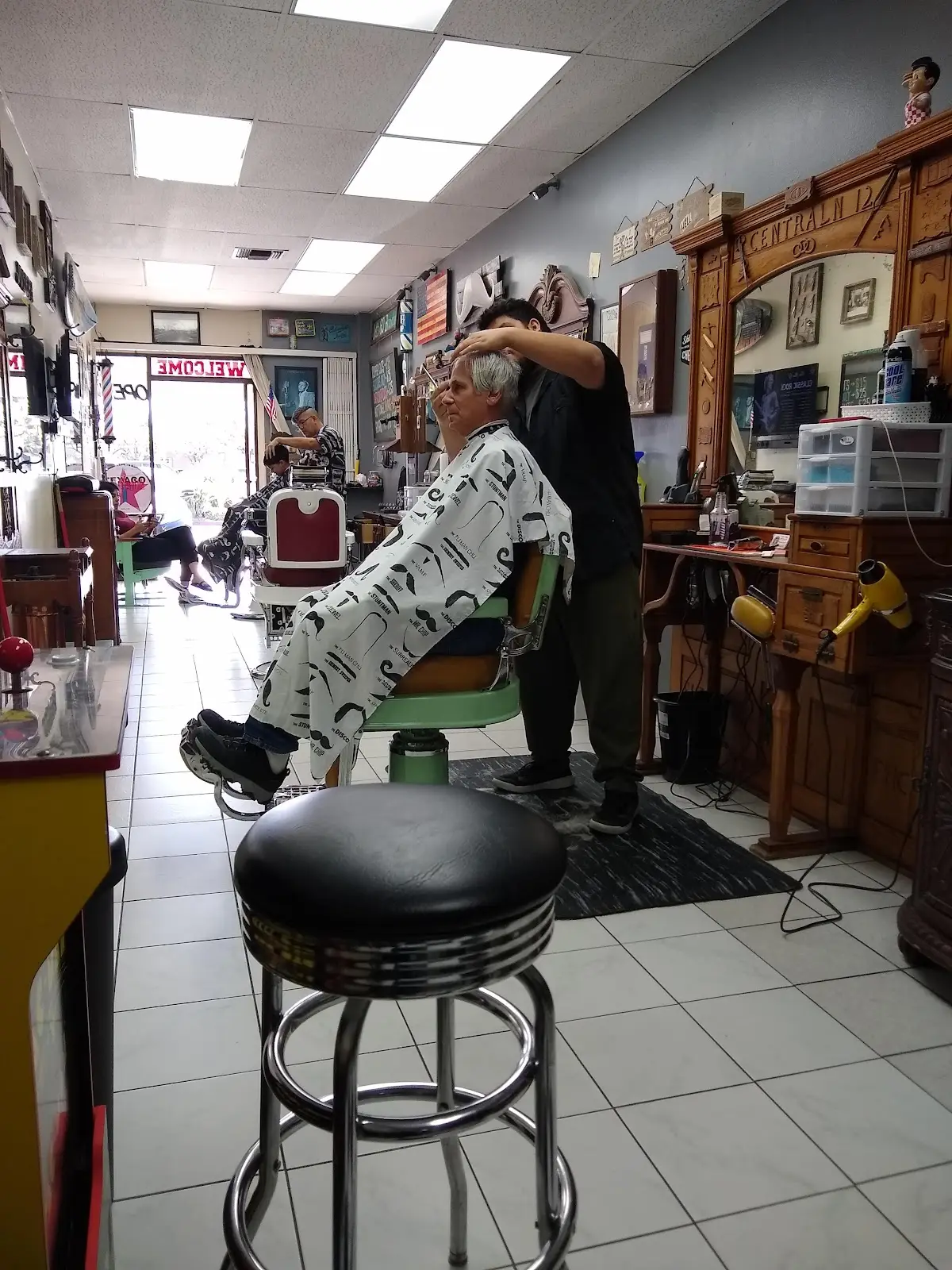 Inside ABC3 Barber Studio: classic barber chairs, wood-framed mirrors, and barbers at work